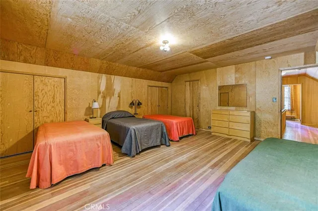 a bedroom with two beds and painted walls