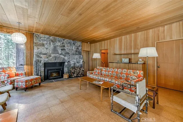 a living room with furniture a fireplace and a table