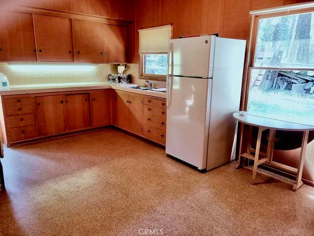 a kitchen with refrigerator and window