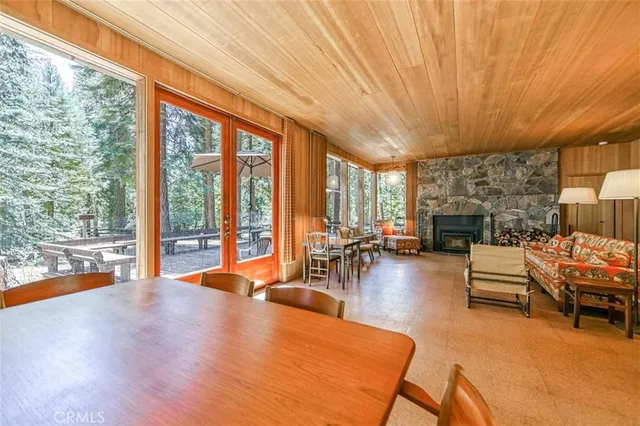 a living room with furniture a fireplace and city view