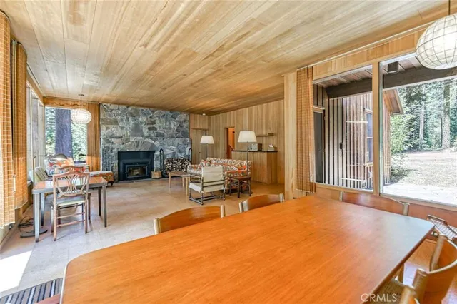 a living room with furniture a fireplace and a table