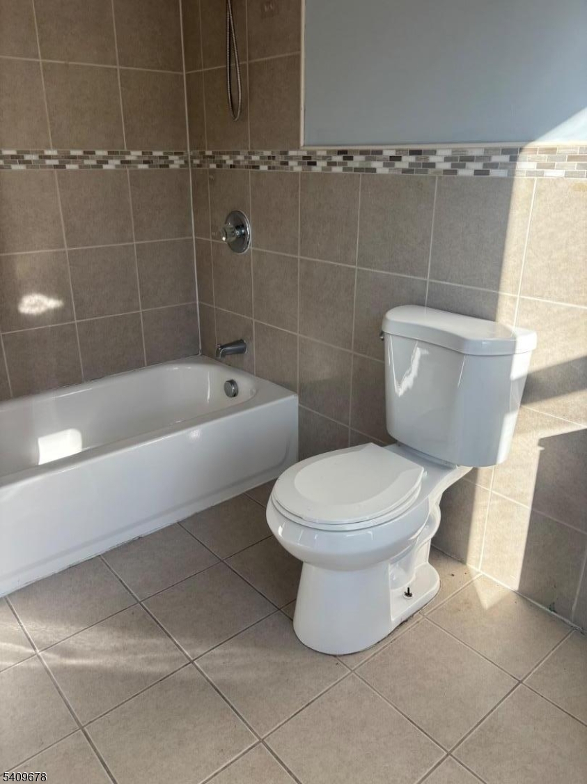 309 South 11th Street, Unit 2 Newark, NJ 07103 - Photo 13 of 13 a white toilet sitting next to a bathtub