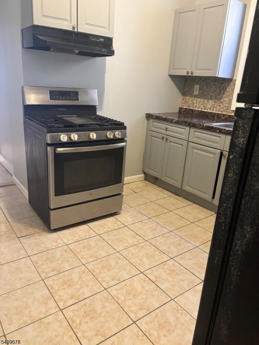 309 South 11th Street, Unit 2 Newark, NJ 07103 - Photo 6 of 13 a kitchen with granite countertop white cabinets and white appliances