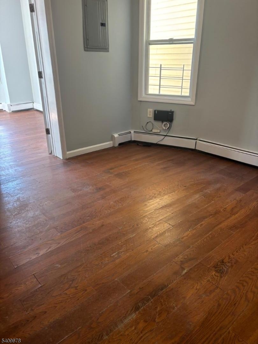 309 South 11th Street, Unit 2 Newark, NJ 07103 - Photo 9 of 13 an empty room with wooden floor and windows
