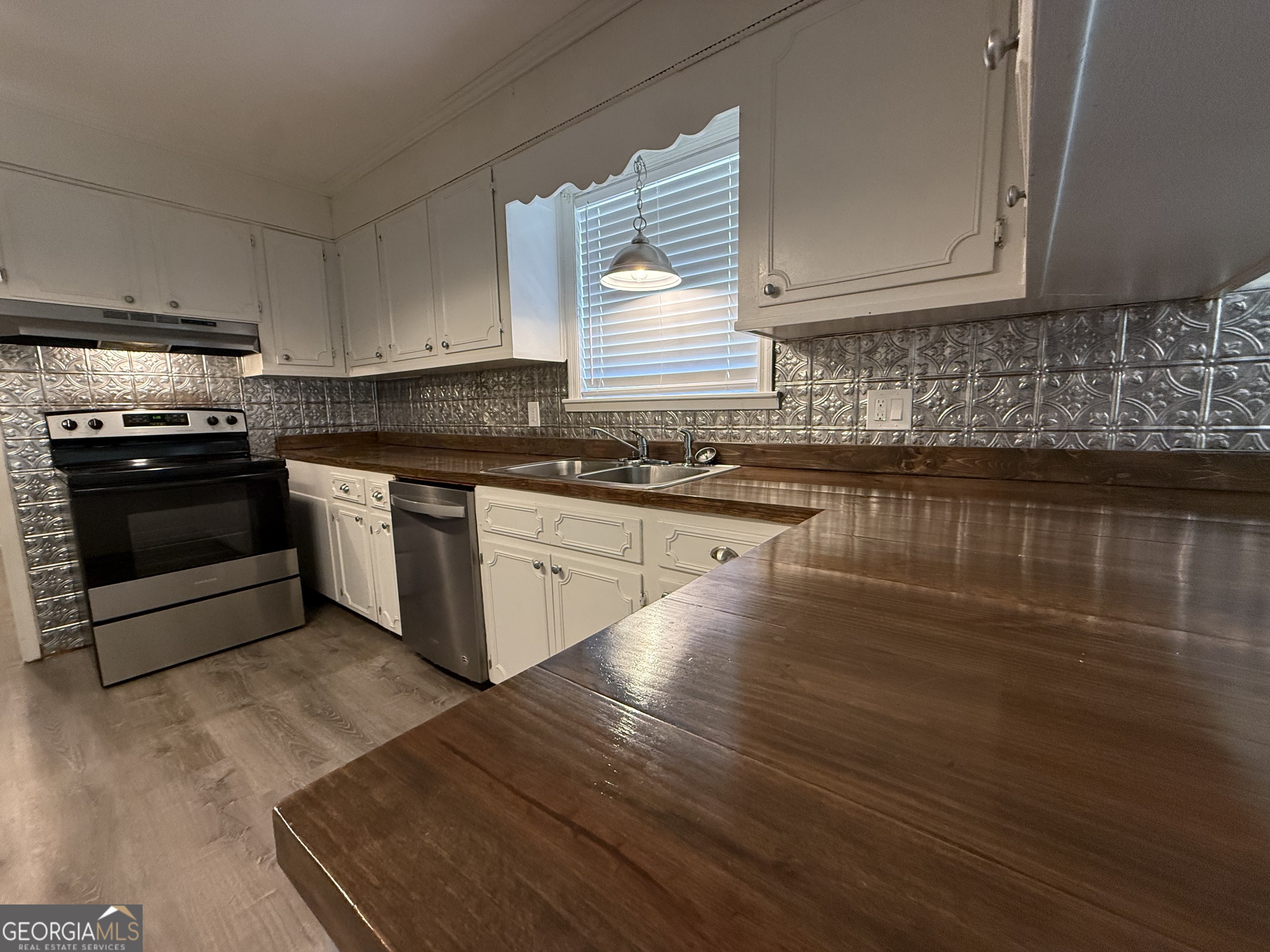 108 Plum Street Dublin, GA 31021 - Photo 25 of 33 a kitchen with stainless steel appliances granite countertop a stove a sink and a microwave