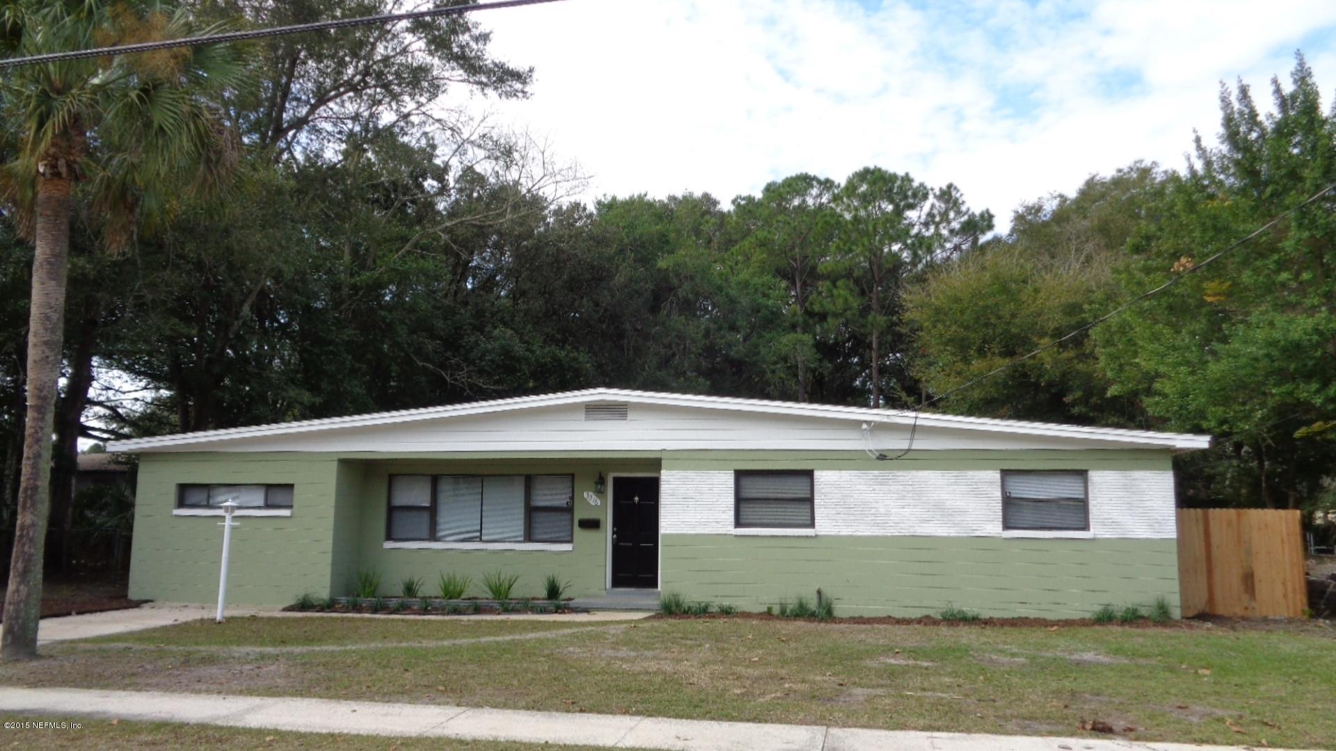 3376 Rogero Road Jacksonville, FL 32277 - Photo 1 of 7 a front view of a house with a garden