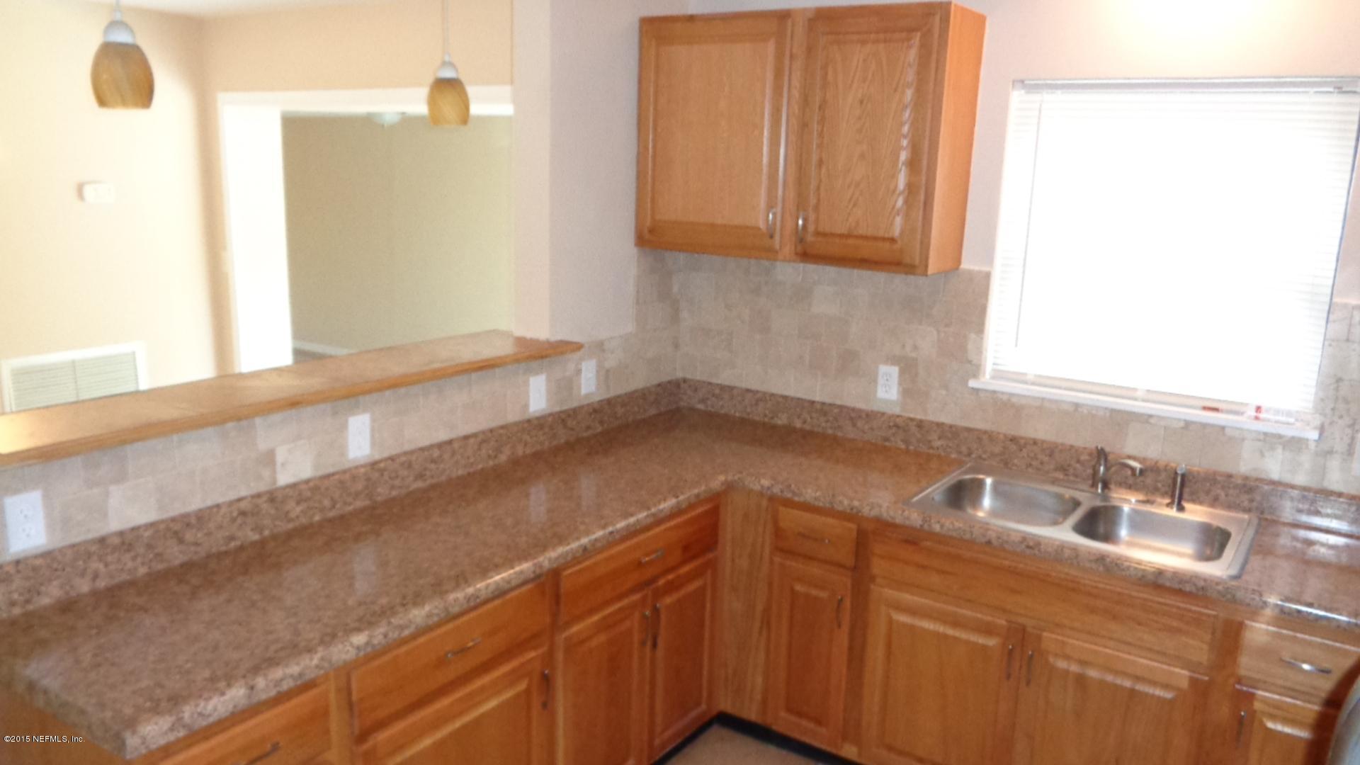 3376 Rogero Road Jacksonville, FL 32277 - Photo 4 of 7 a bathroom with a sink and a mirror