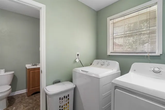 a bathroom with a toilet sink and a window