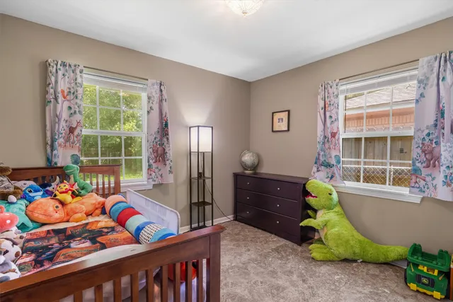 a bedroom with furniture and a window