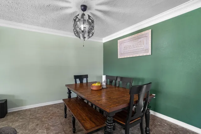 a view of a dining room with furniture and chandelier