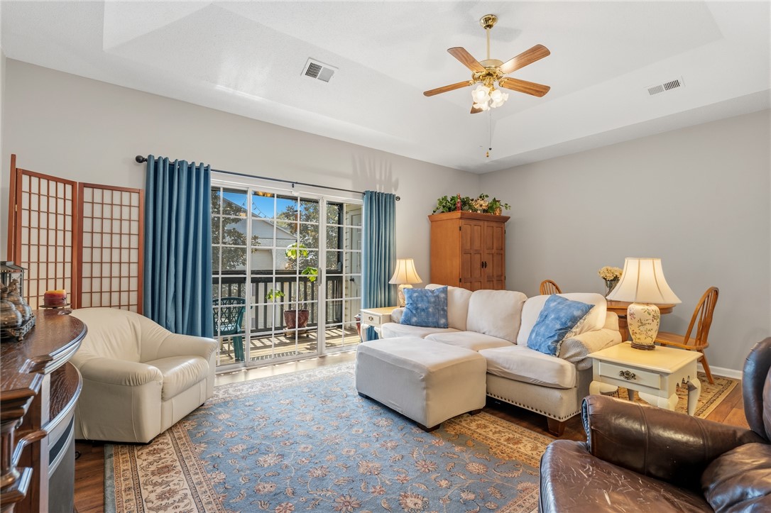 160 Wexford Drive, Unit 206 Anderson, SC 29621 - Photo 9 of 31 A comfortable living space offers seamless indoor-outdoor living with a private screened balcony accessible through sliding glass doors.