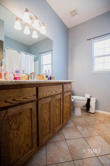 408 Acacia Street Ridgecrest, CA 93555 - Photo 27 of 32 a kitchen with a sink and cabinets