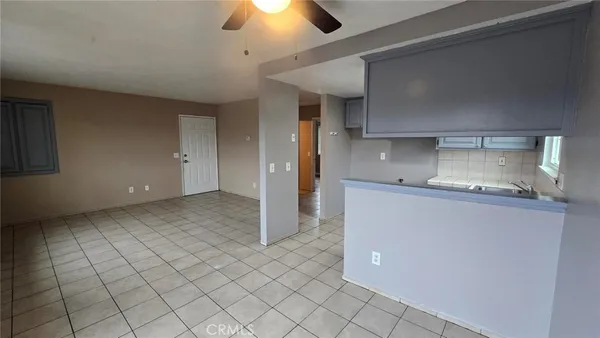 a kitchen with kitchen island granite countertop a sink cabinets and stainless steel appliances