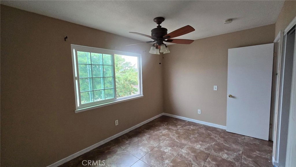 308 North Millard Avenue, Unit 312 Rialto, CA 92376 - Photo 6 of 16 a view of a big room with a ceiling fan and a window