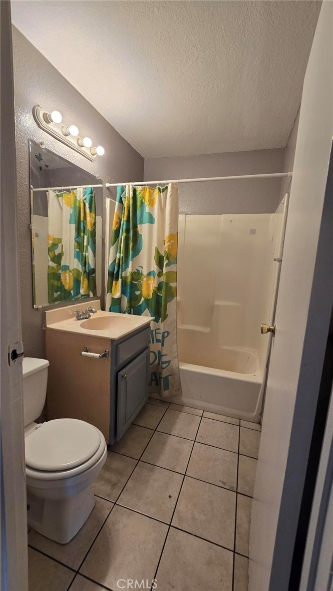 308 North Millard Avenue, Unit 312 Rialto, CA 92376 - Photo 7 of 16 a bathroom with a toilet a sink a bath tub and shower