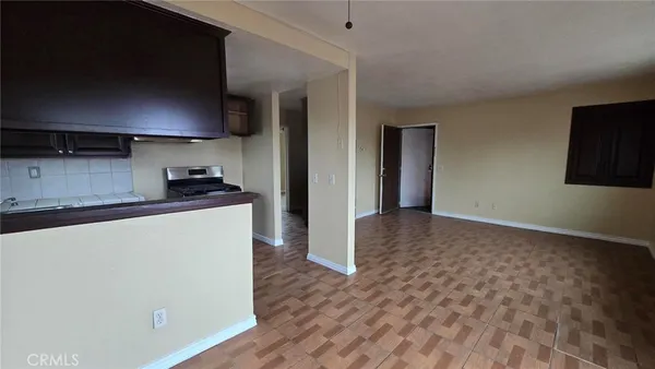 a kitchen with granite countertop a sink and a stove top oven