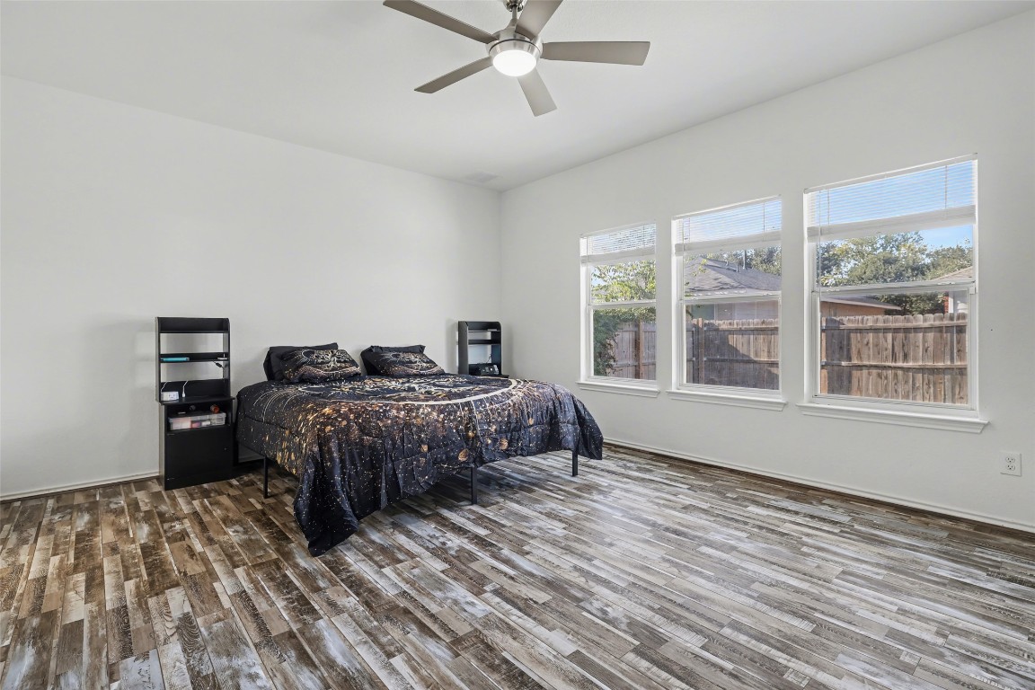 1520 Tonia Loop Round Rock, TX 78665 - Photo 13 of 32 a bedroom with a bed and wooden floor