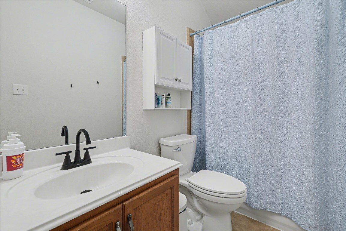 1520 Tonia Loop Round Rock, TX 78665 - Photo 20 of 32 a bathroom with a sink a toilet and mirror