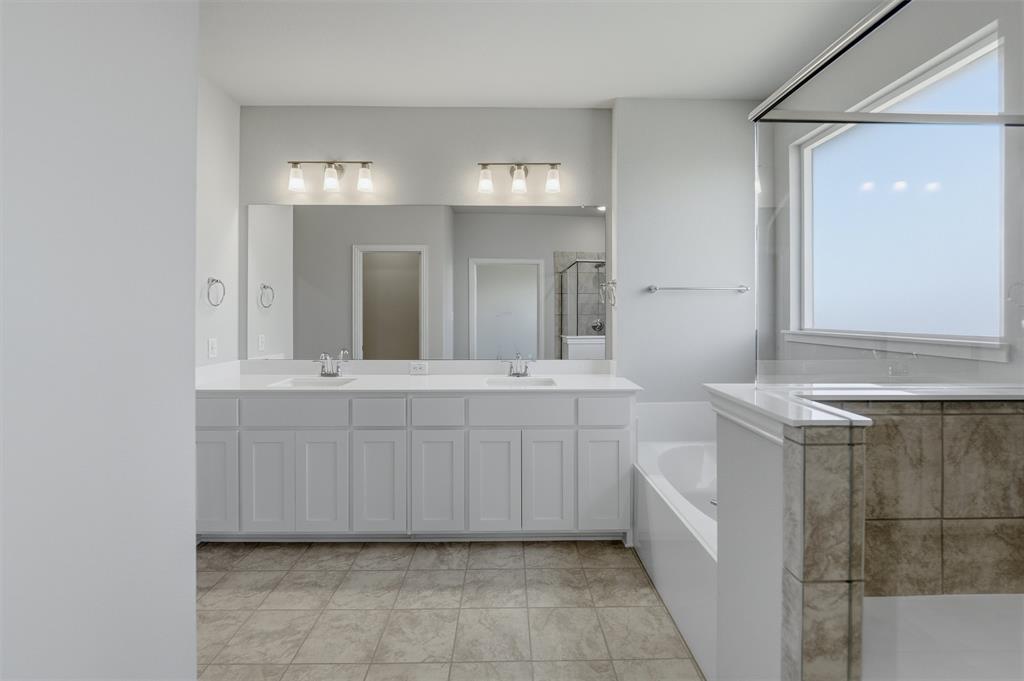 1225 Sabine River Lane Springtown, TX 76082 - Photo 16 of 25 Full bath featuring a shower stall, double vanity, and a bath