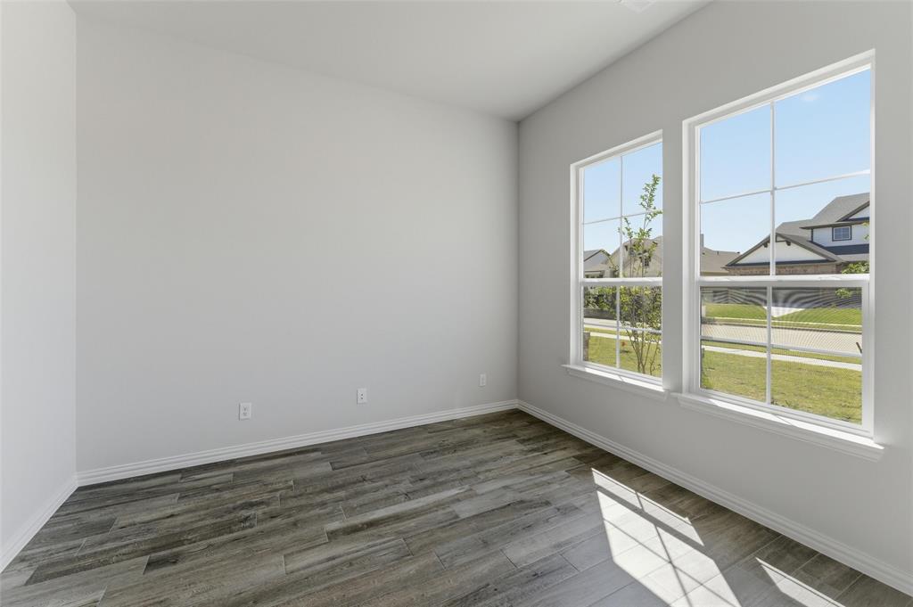 1225 Sabine River Lane Springtown, TX 76082 - Photo 5 of 25 Empty room featuring dark wood finished floors and baseboards