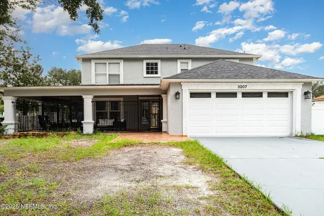 a front view of a house with a yard and garage