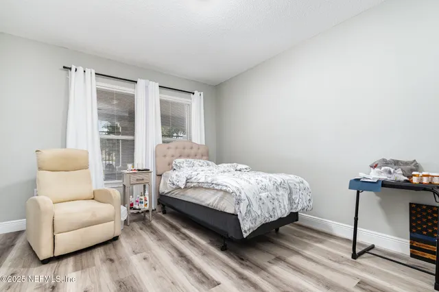 a bedroom with a bed and a chair