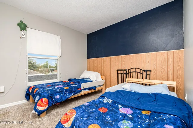 a bedroom with furniture and a window