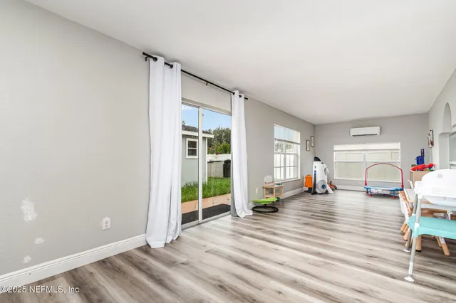 a view of a livingroom with wooden floor and a window