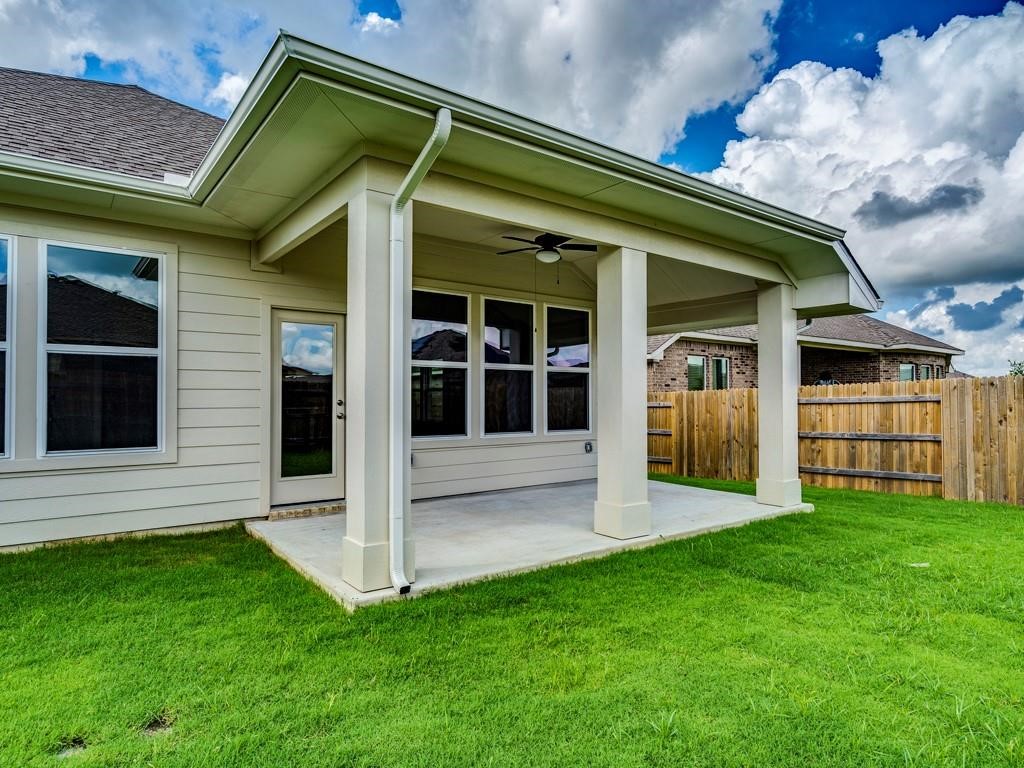 270 Rimrock Court Bastrop, TX 78602 - Photo 31 of 34 Step outside to a covered patio and landscaped backyard — a peaceful escape from the bustle of city life.