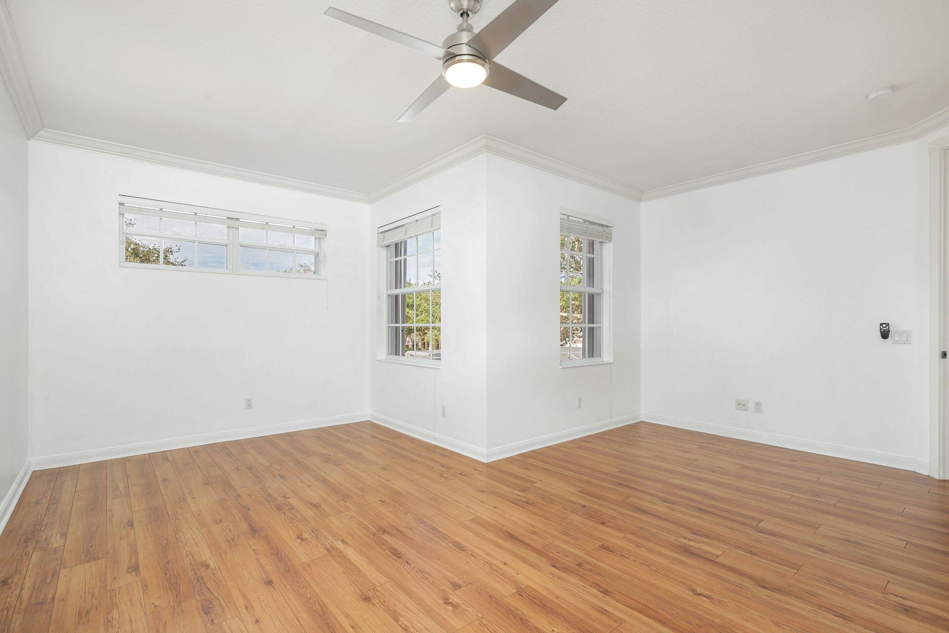 214 New Haven Boulevard Jupiter, FL 33458 - Photo 20 of 40 a view of empty room with wooden floor and fan