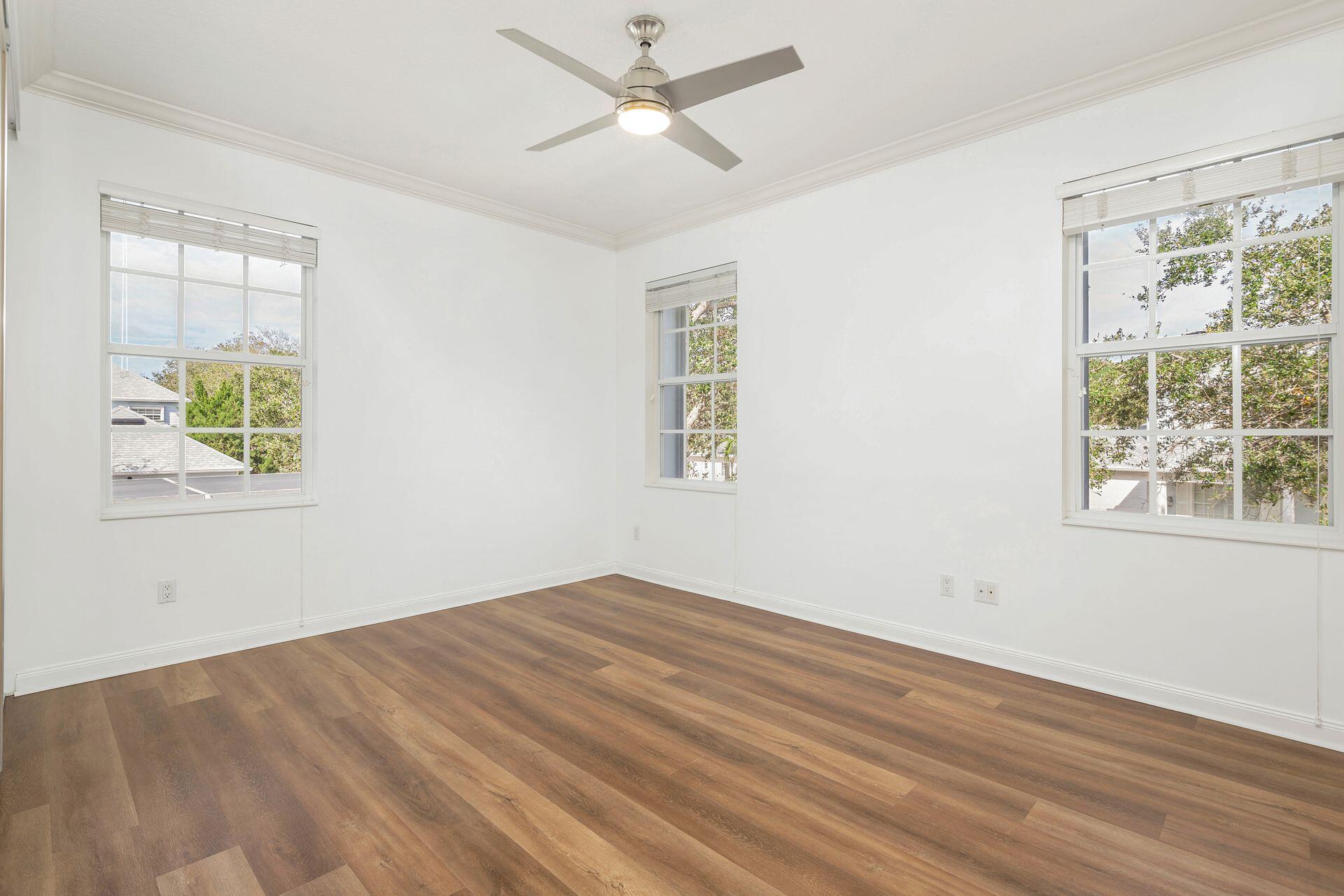 214 New Haven Boulevard Jupiter, FL 33458 - Photo 23 of 40 a view of empty room with wooden floor and fan