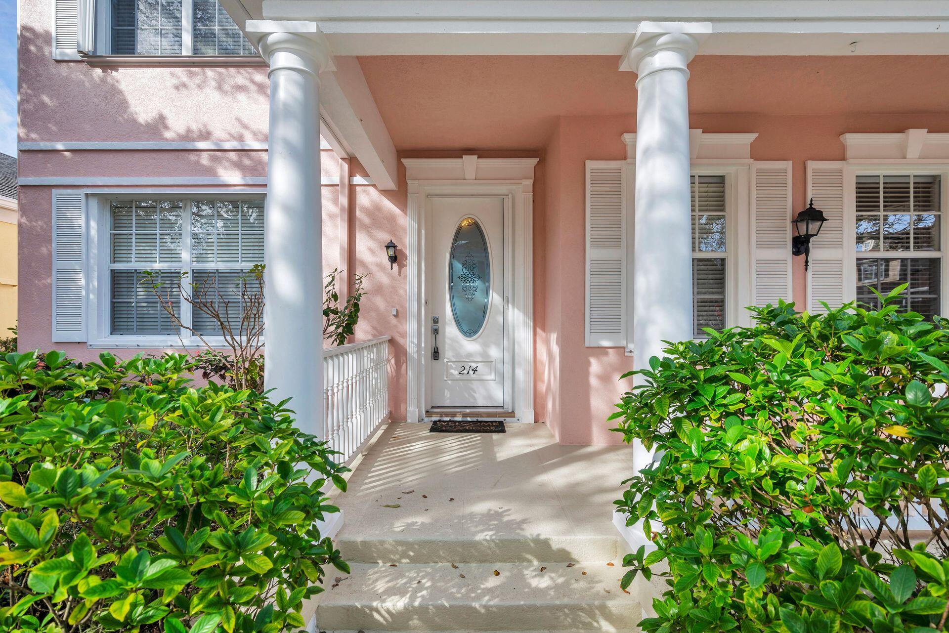 214 New Haven Boulevard Jupiter, FL 33458 - Photo 4 of 40 a front view of a building with a garden