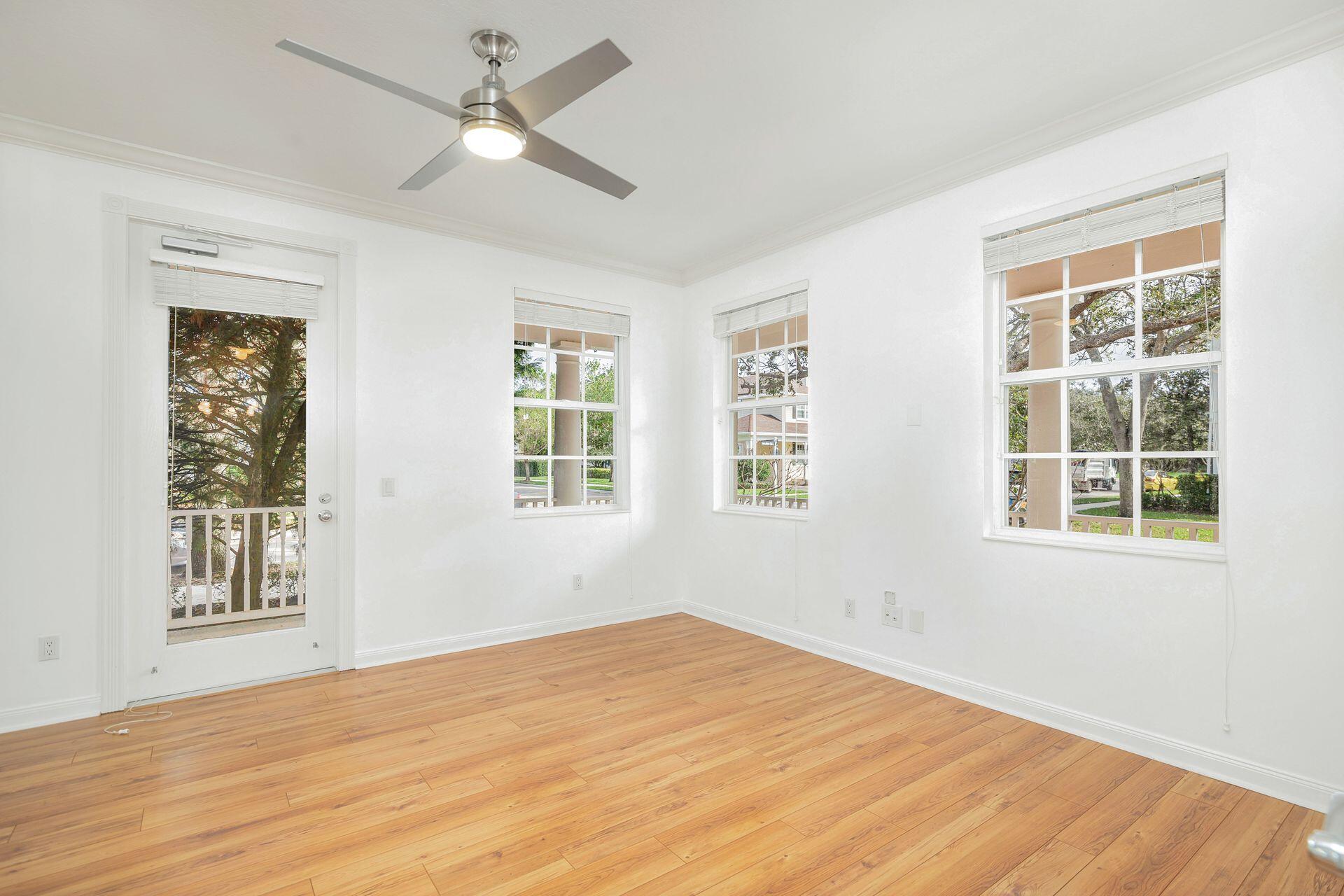 214 New Haven Boulevard Jupiter, FL 33458 - Photo 8 of 40 a view of an empty room with a window and wooden floor