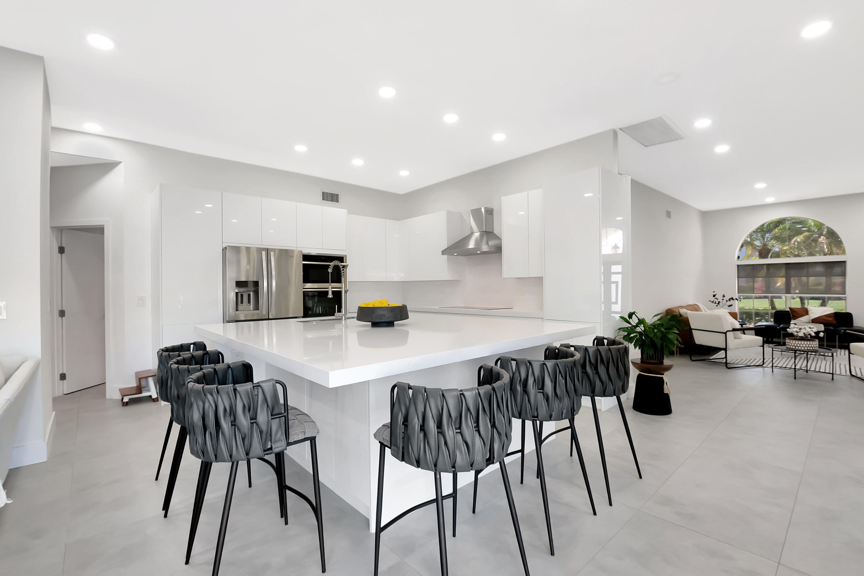 22330 Kettle Creek Way Boca Raton, FL 33428 - Photo 2 of 75 a kitchen with stainless steel appliances kitchen island granite countertop a table and chairs in it