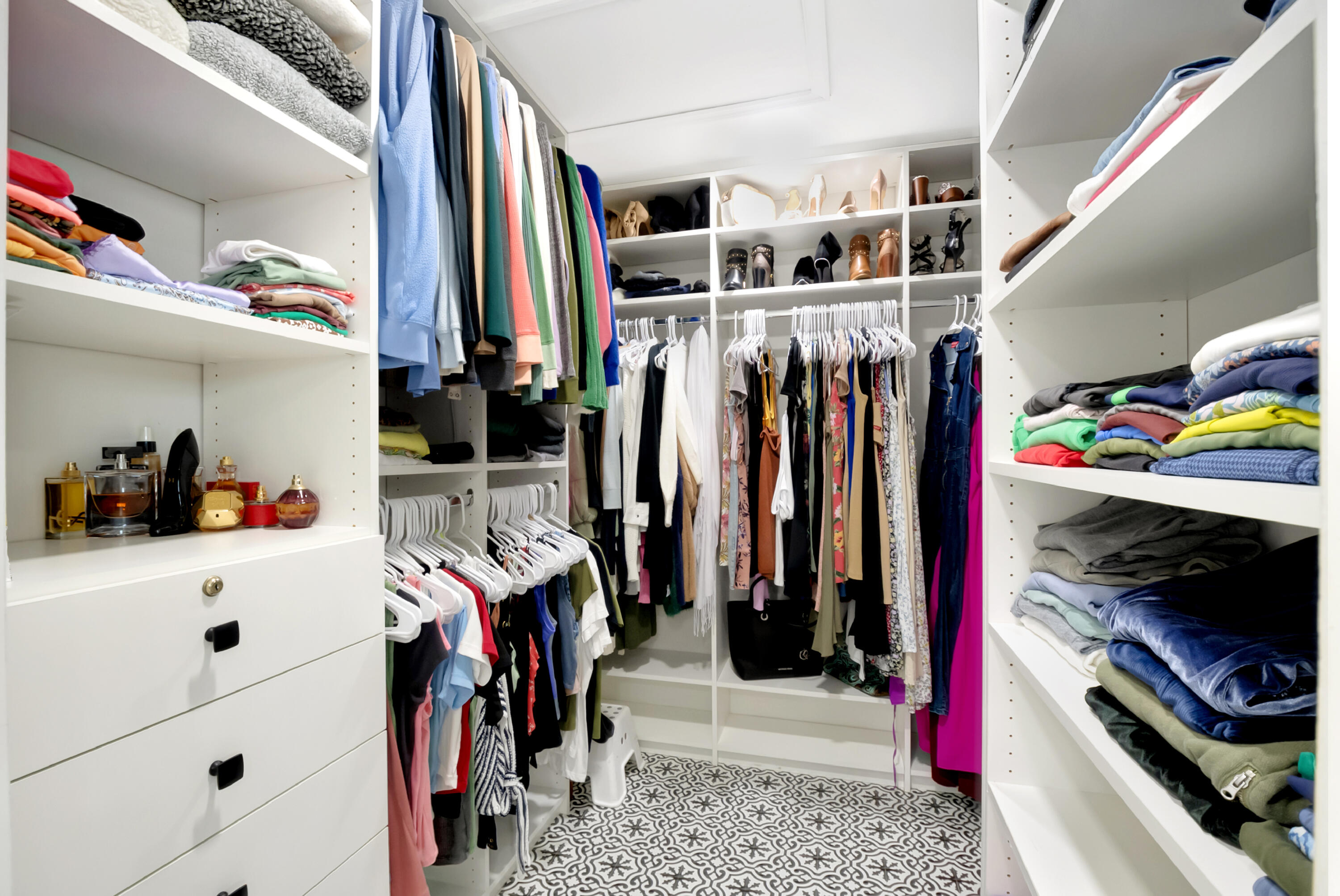 22330 Kettle Creek Way Boca Raton, FL 33428 - Photo 32 of 75 a view of walk in closet with clothes and shoes