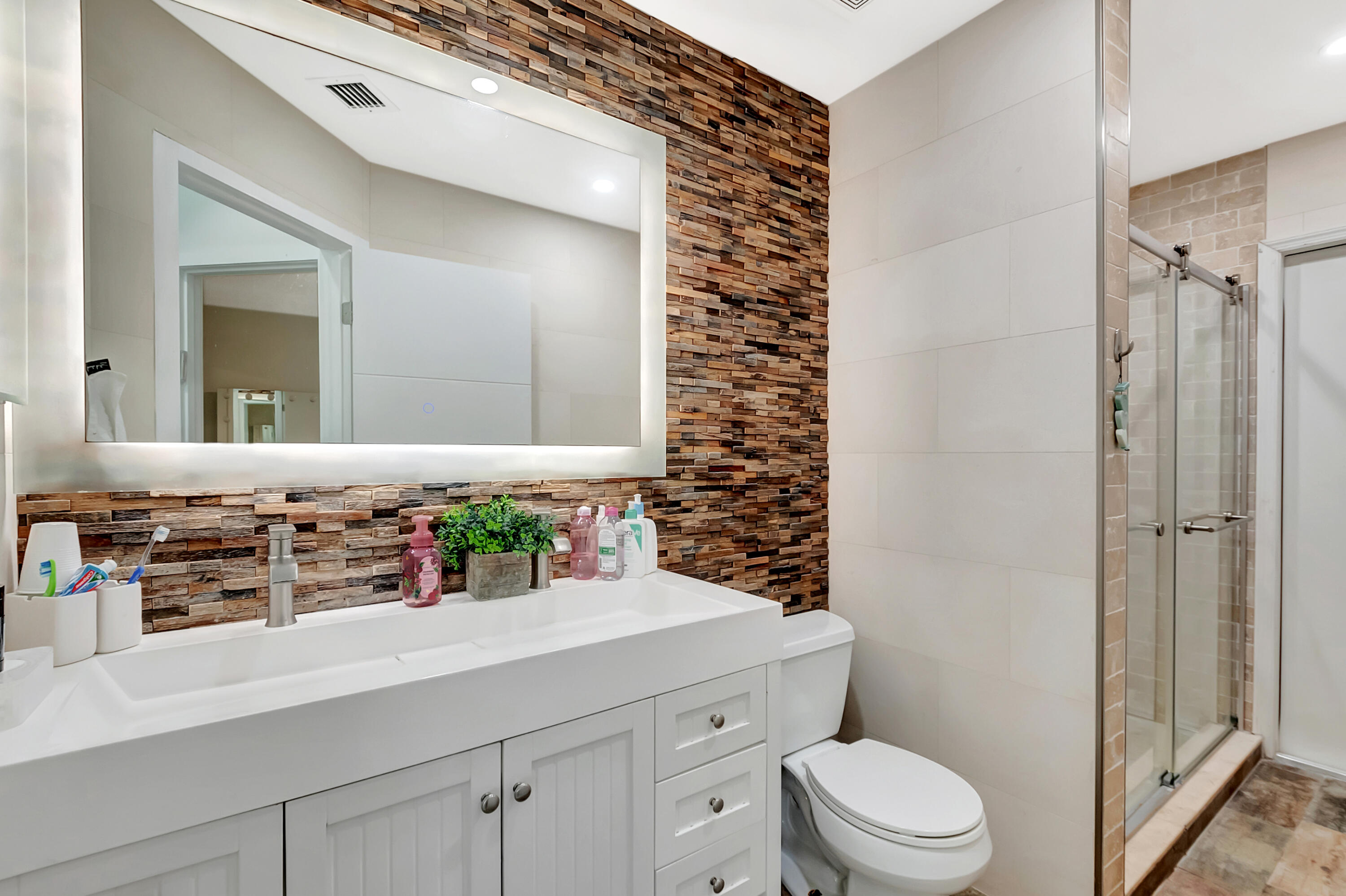 22330 Kettle Creek Way Boca Raton, FL 33428 - Photo 44 of 75 a bathroom with a sink a toilet a mirror and shower