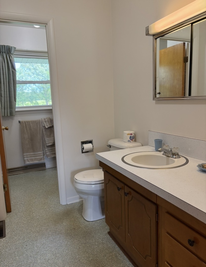 609 9th Avenue Ottawa, IL 61350 - Photo 18 of 28 a bathroom with a granite countertop sink toilet and mirror
