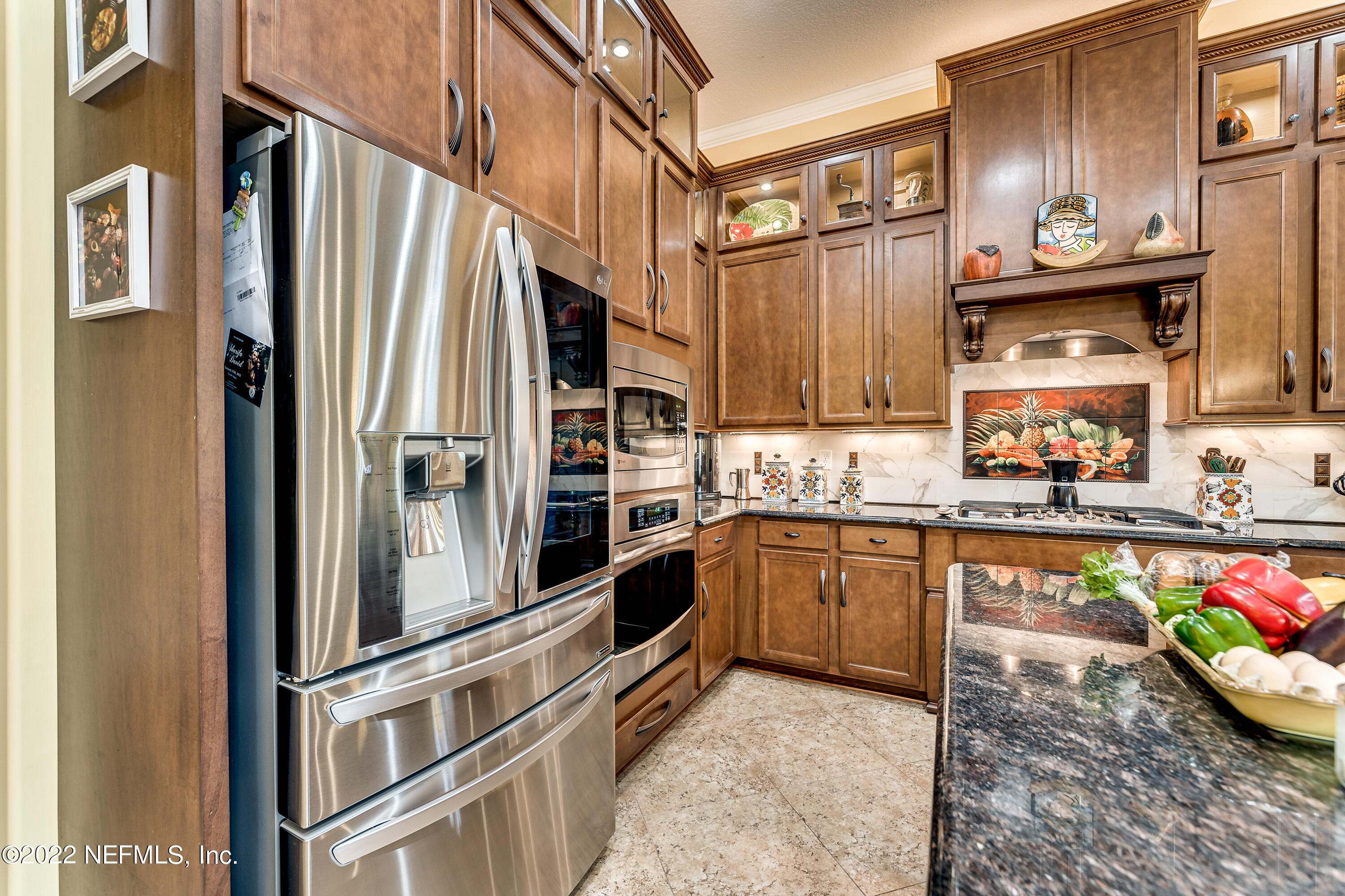 571 Saddlestone Drive Jacksonville, FL 32259 - Photo 20 of 65 a kitchen with stainless steel appliances granite countertop a refrigerator a stove and a sink with wooden floor