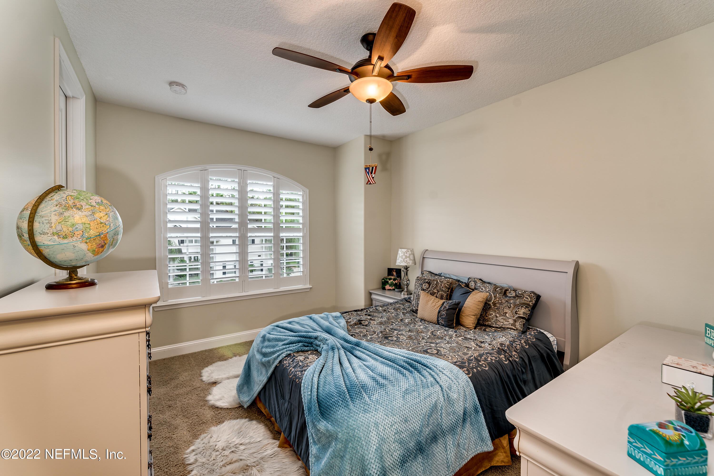 571 Saddlestone Drive Jacksonville, FL 32259 - Photo 40 of 65 a bedroom with a bed and a chandelier