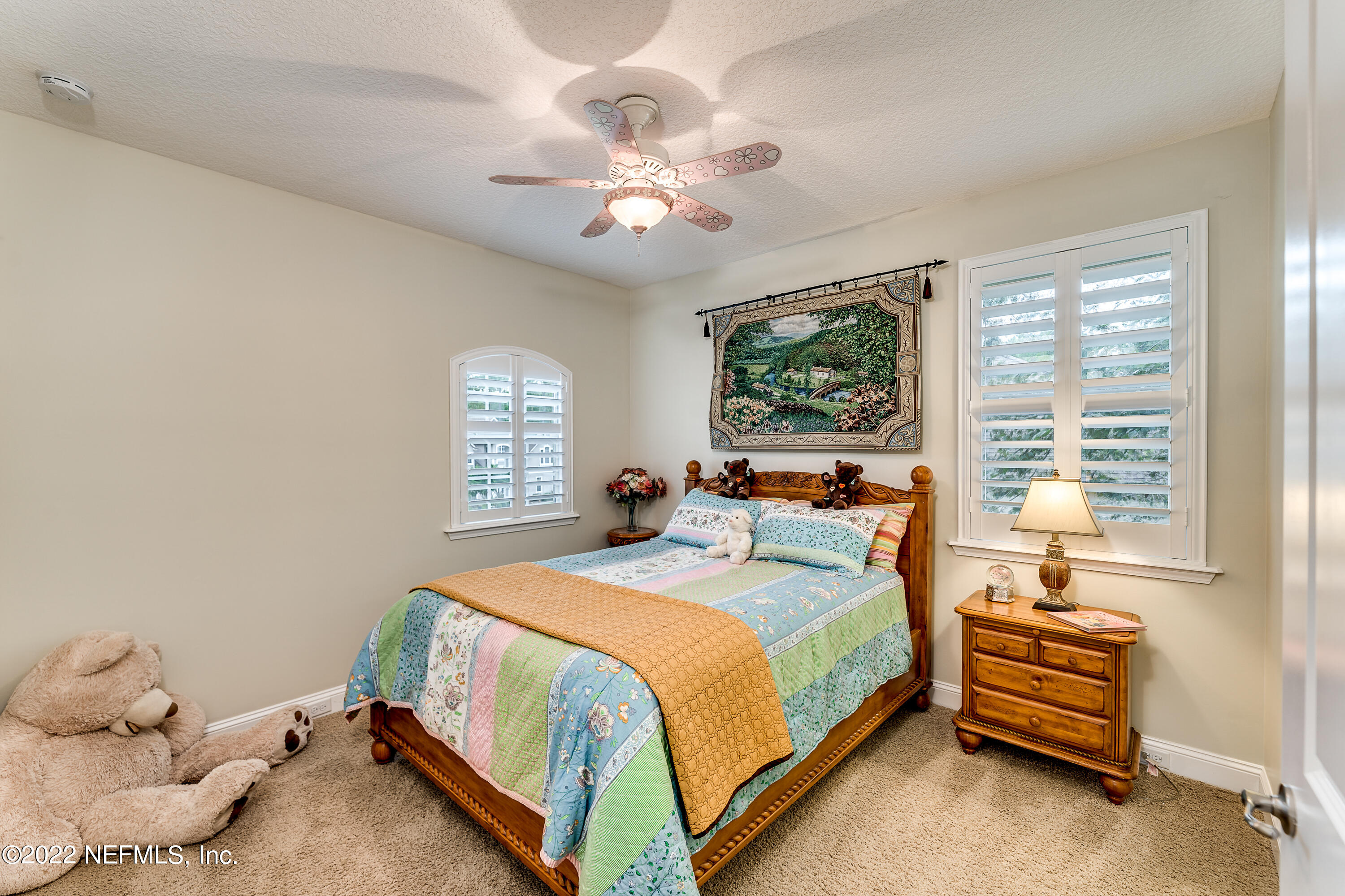 571 Saddlestone Drive Jacksonville, FL 32259 - Photo 43 of 65 a bedroom with a bed and a chandelier