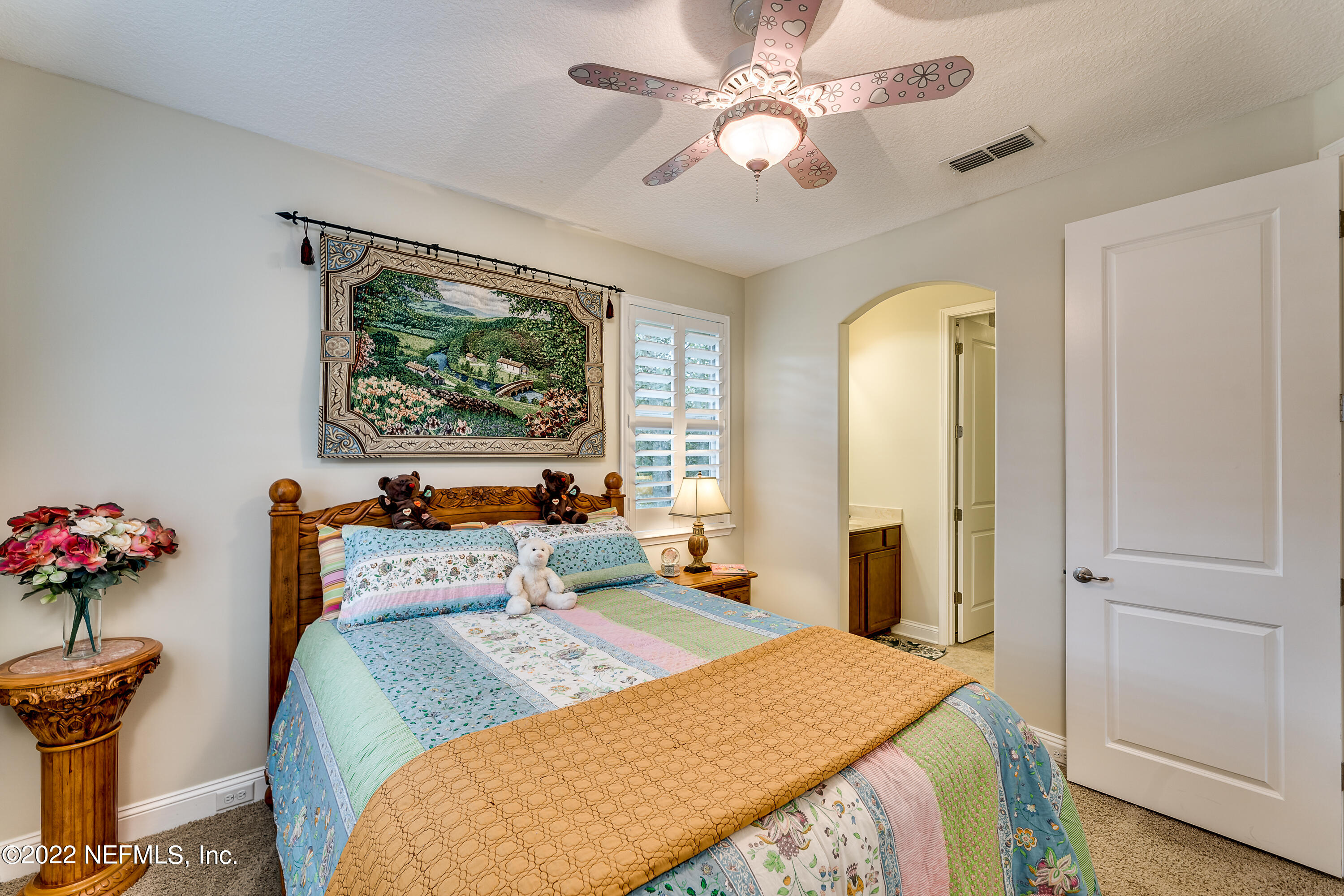 571 Saddlestone Drive Jacksonville, FL 32259 - Photo 44 of 65 a bedroom with a bed and a chandelier