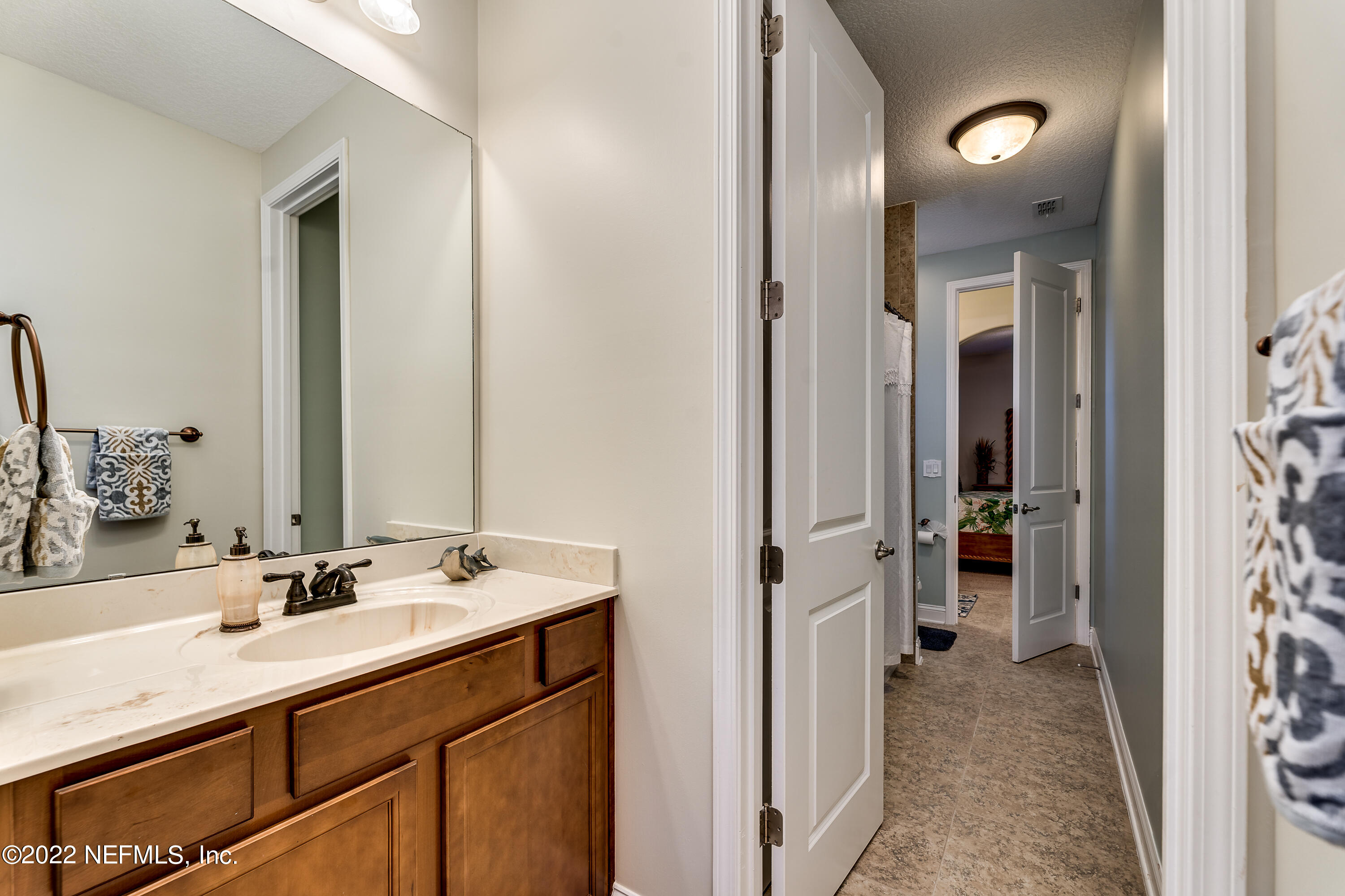 571 Saddlestone Drive Jacksonville, FL 32259 - Photo 45 of 65 a en suite bathroom with a sink double vanity and a mirror