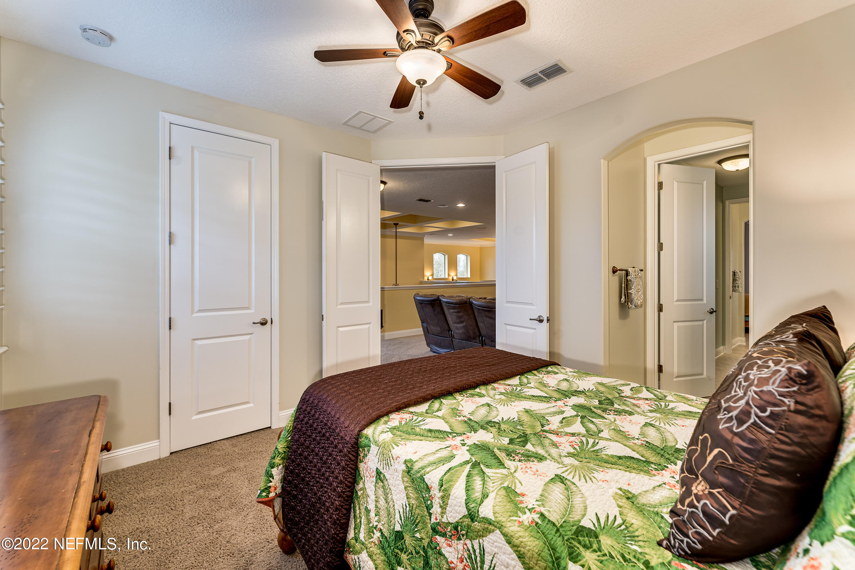 571 Saddlestone Drive Jacksonville, FL 32259 - Photo 47 of 65 a bedroom with a bed and a chandelier