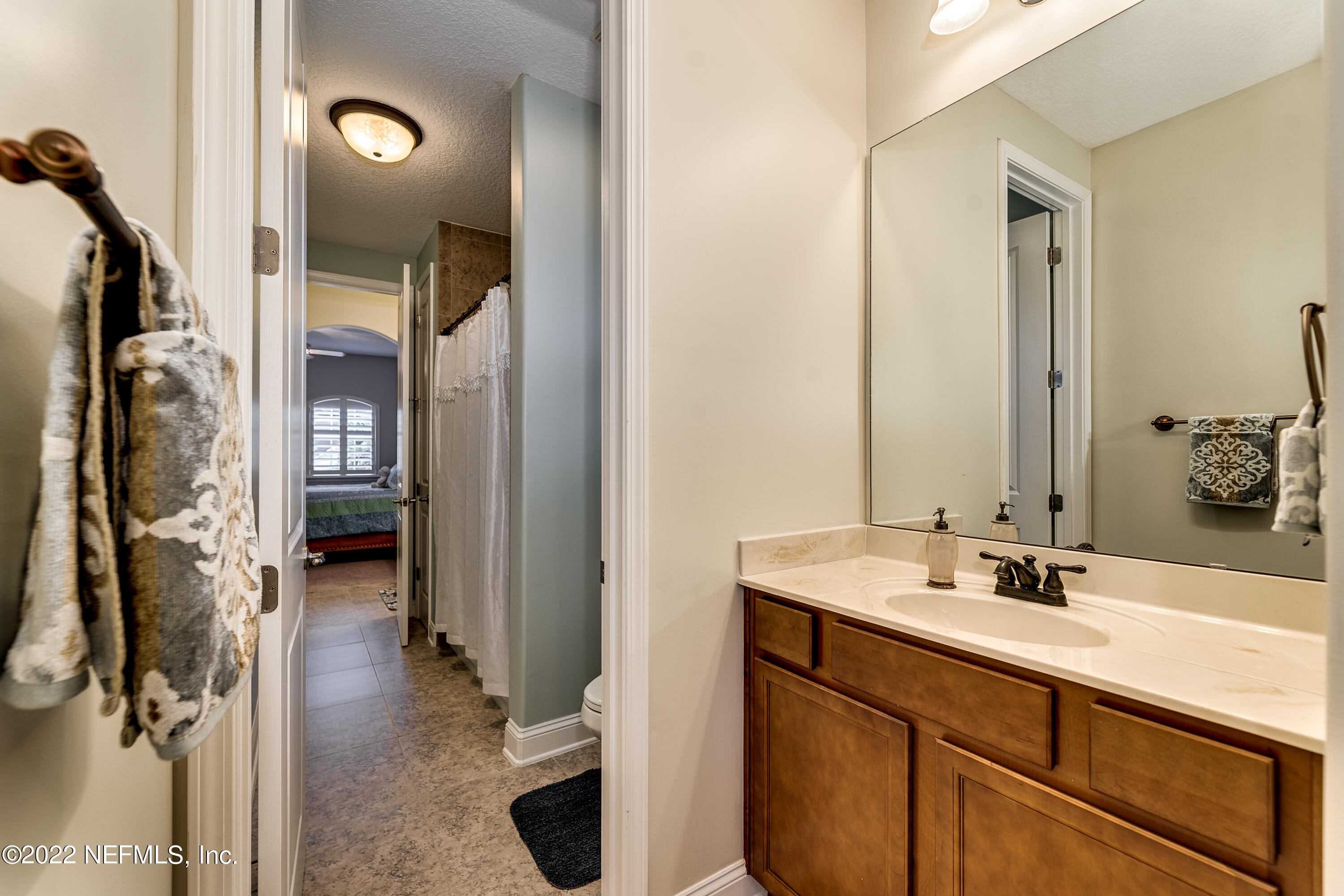 571 Saddlestone Drive Jacksonville, FL 32259 - Photo 48 of 65 a en suite bathroom with a sink double vanity and a mirror