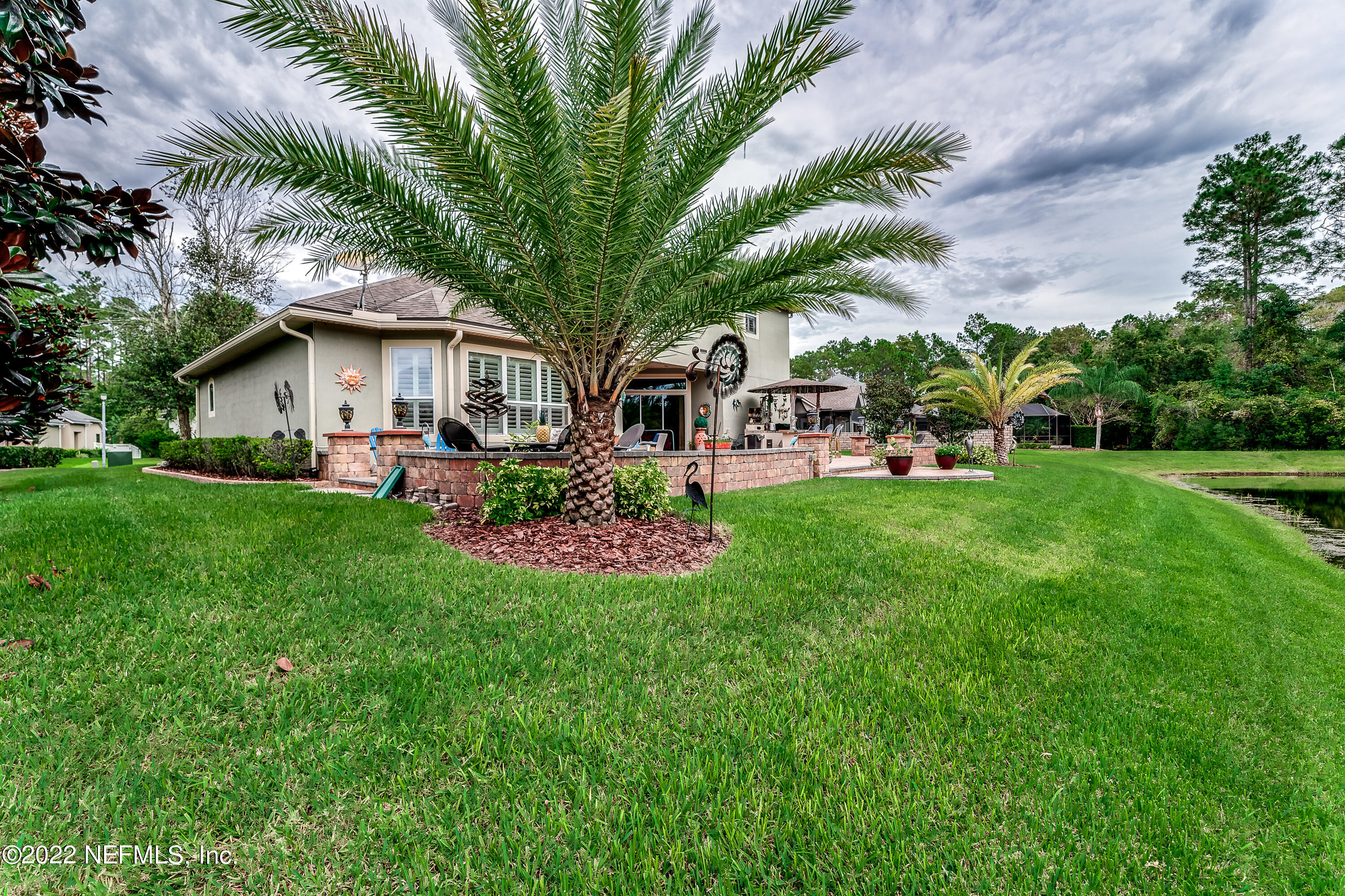 571 Saddlestone Drive Jacksonville, FL 32259 - Photo 59 of 65 a front view of a house with garden and trees