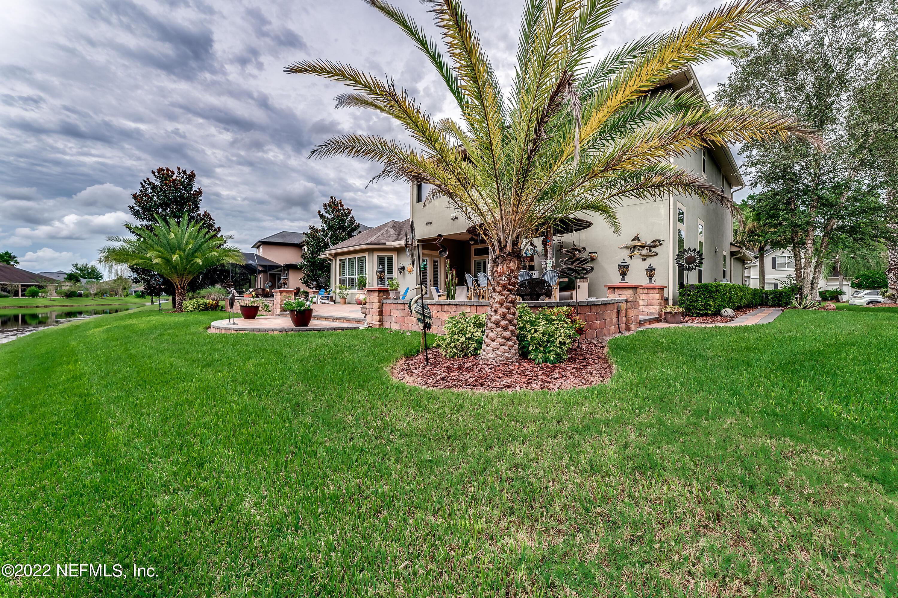 571 Saddlestone Drive Jacksonville, FL 32259 - Photo 61 of 65 a front view of a house with a garden and trees