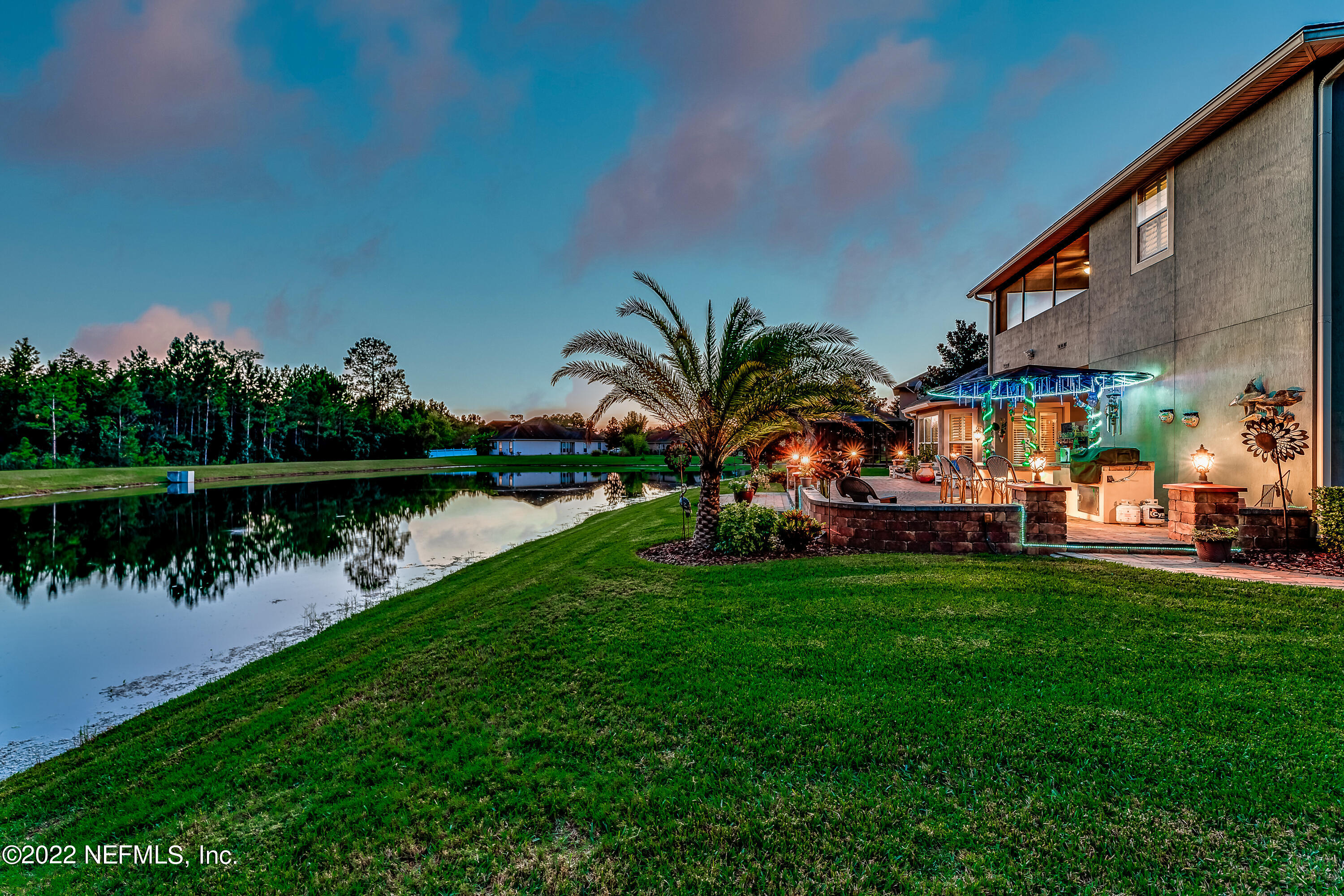 571 Saddlestone Drive Jacksonville, FL 32259 - Photo 65 of 65 a view of a lake with a building and a big yard