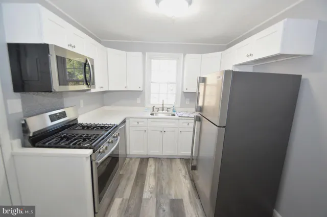 a kitchen with a sink stove and refrigerator