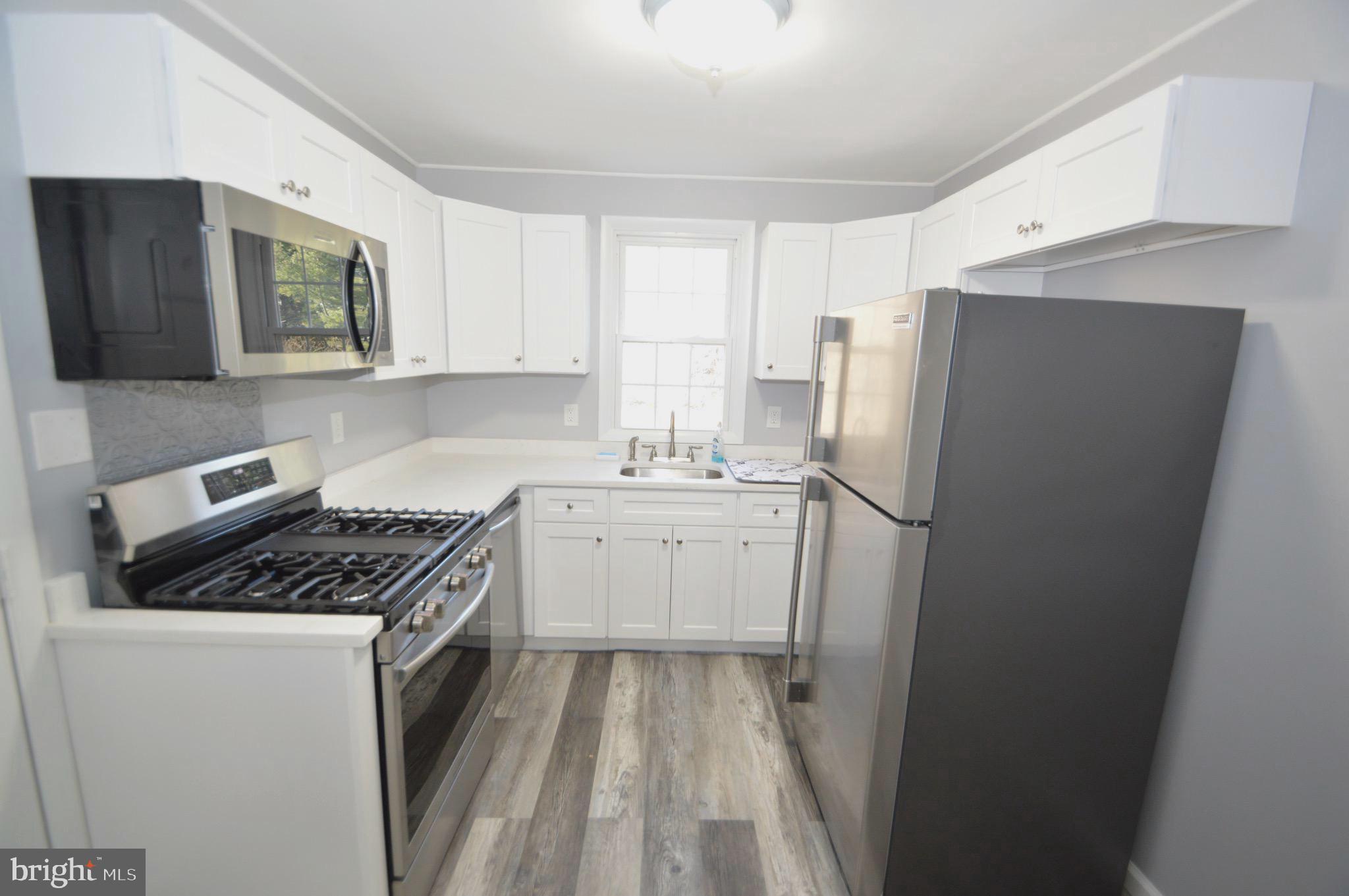 267 Mott Avenue Burlington, NJ 08016 - Photo 8 of 18 a kitchen with a sink stove and refrigerator