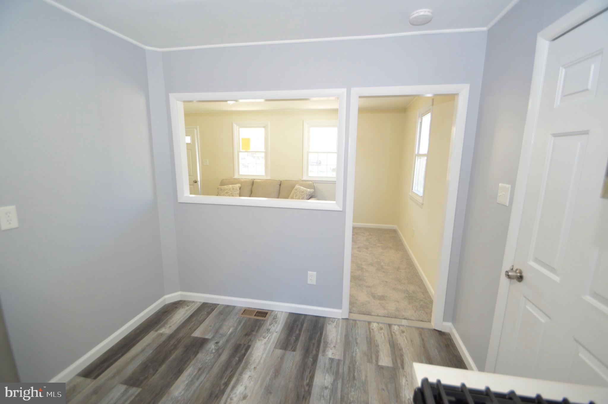 267 Mott Avenue Burlington, NJ 08016 - Photo 9 of 18 an empty room with wooden floor and windows